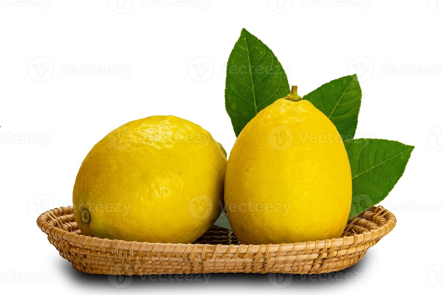 Lemons with leaves in a bamboo tray on white background with clipping path.. photo