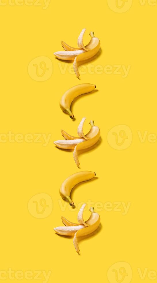 Banner vertical bananas with hard shadows pattern on yellow background photo