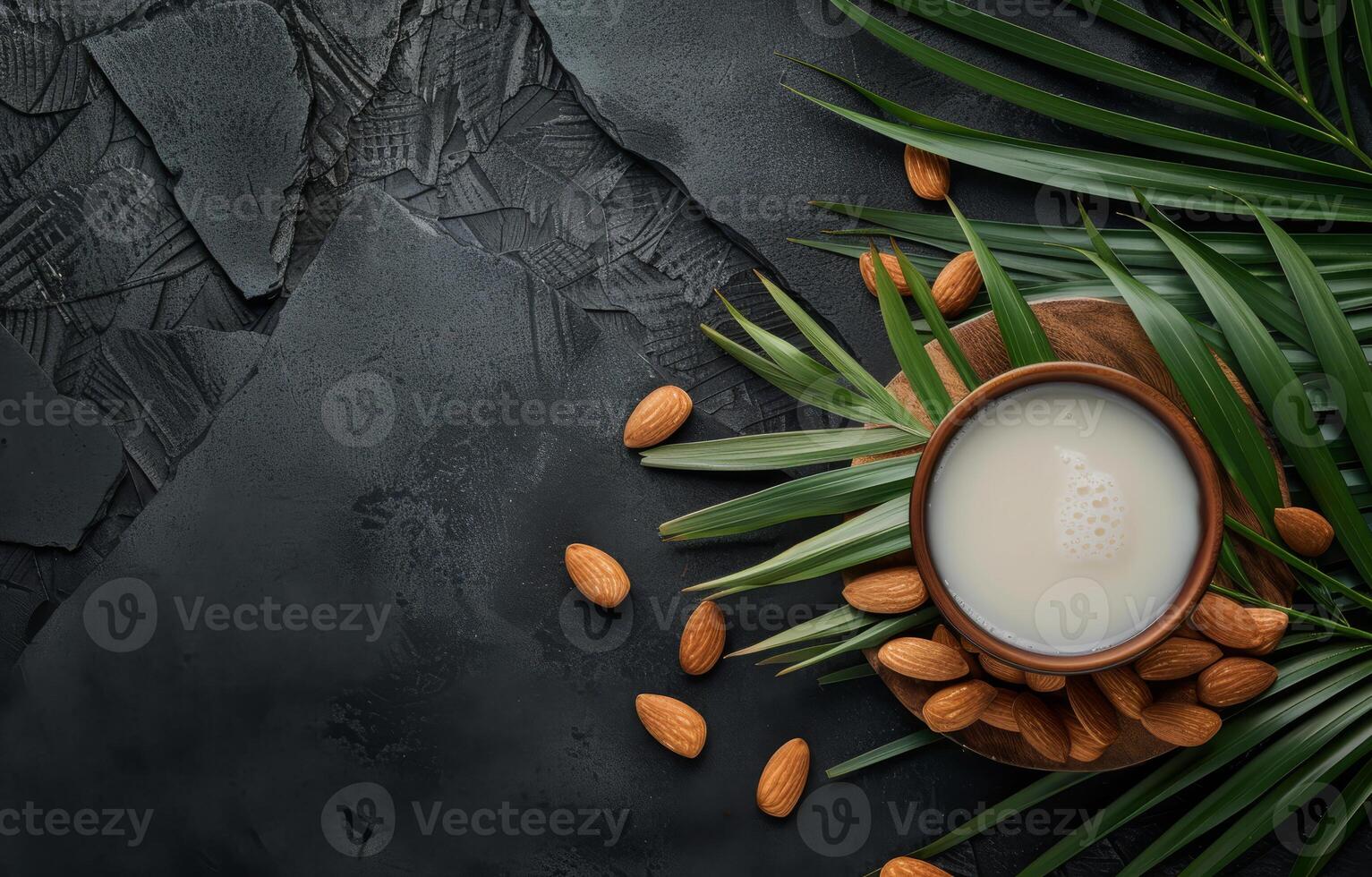 AI generated Almond milk in wooden cup and almonds with palm leaves on black concrete background photo