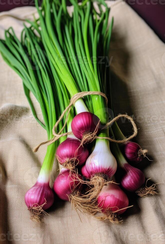 AI generated Fresh green spring onions and red spring onions bunch on linen cloth photo