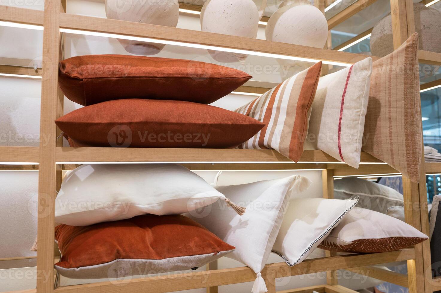 Assorted Decorative Pillows on Wooden Shelves photo