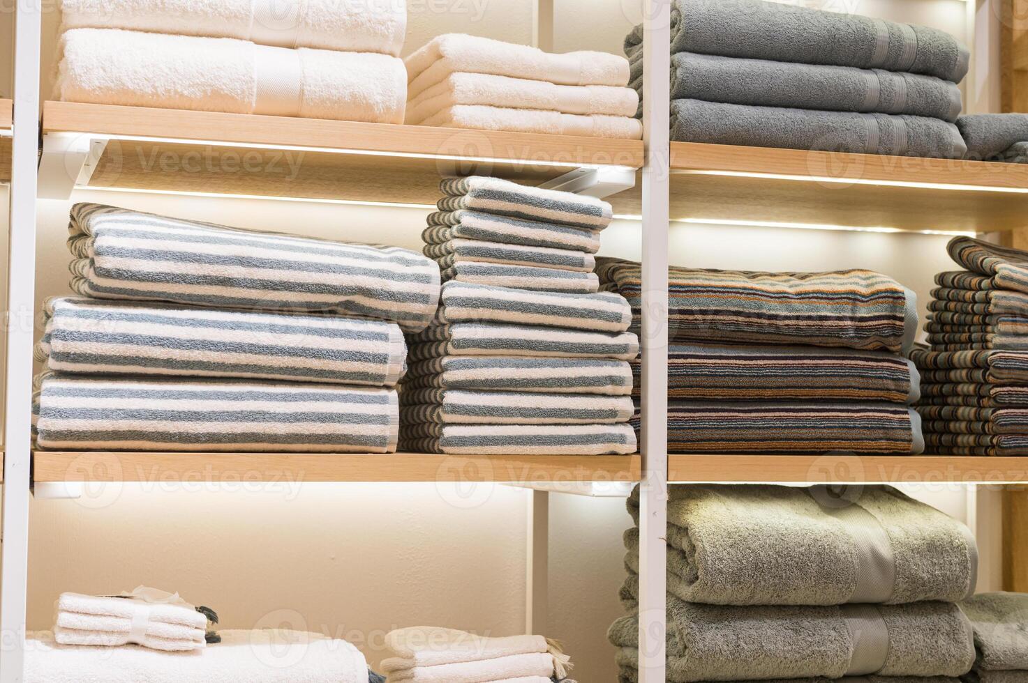 Stacked Towels on Retail Wooden Shelves photo