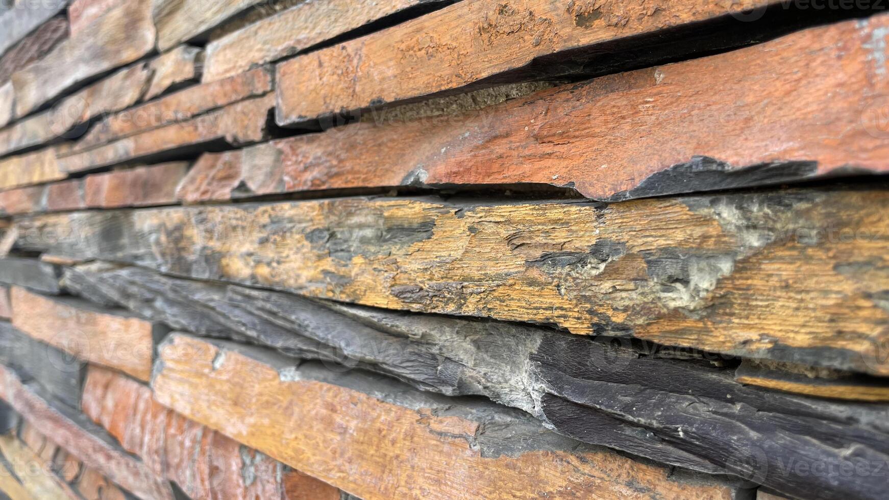 Closeup Wall constructed with stacked stone slabs, abstract background photo