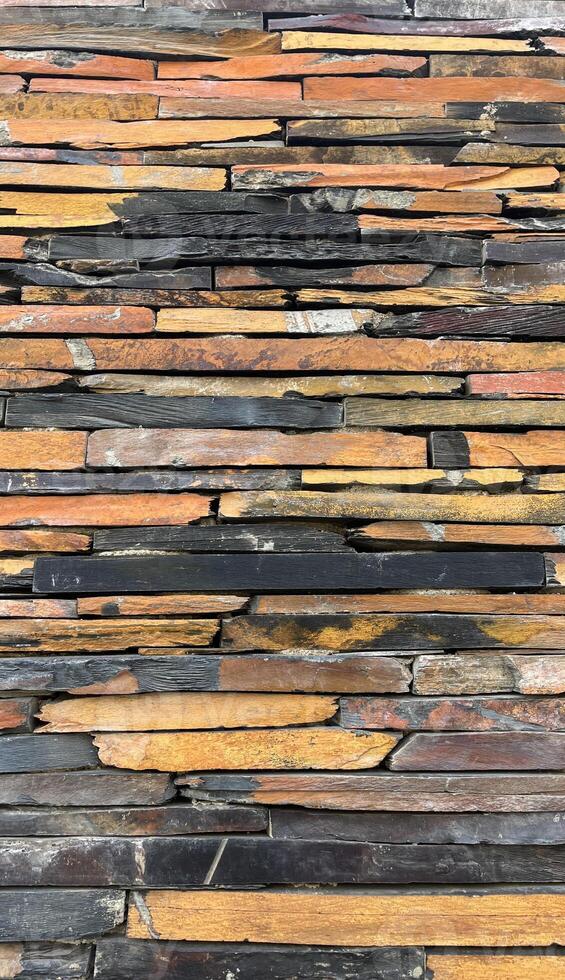 Vertical Wall constructed with stacked stone slabs, abstract background photo