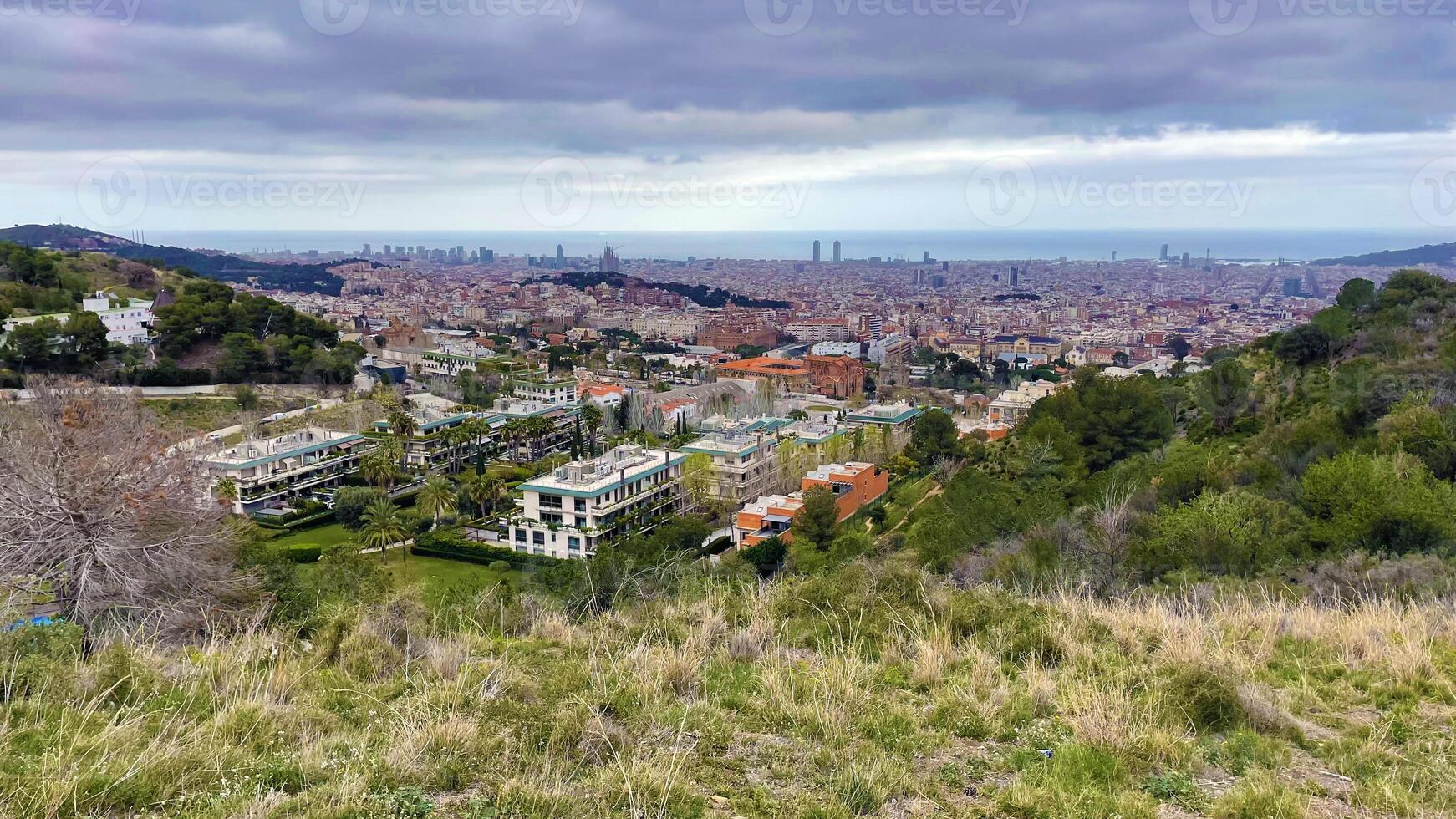 Panoramic view of Barcelona city from the hill, rainy weather landscape photo