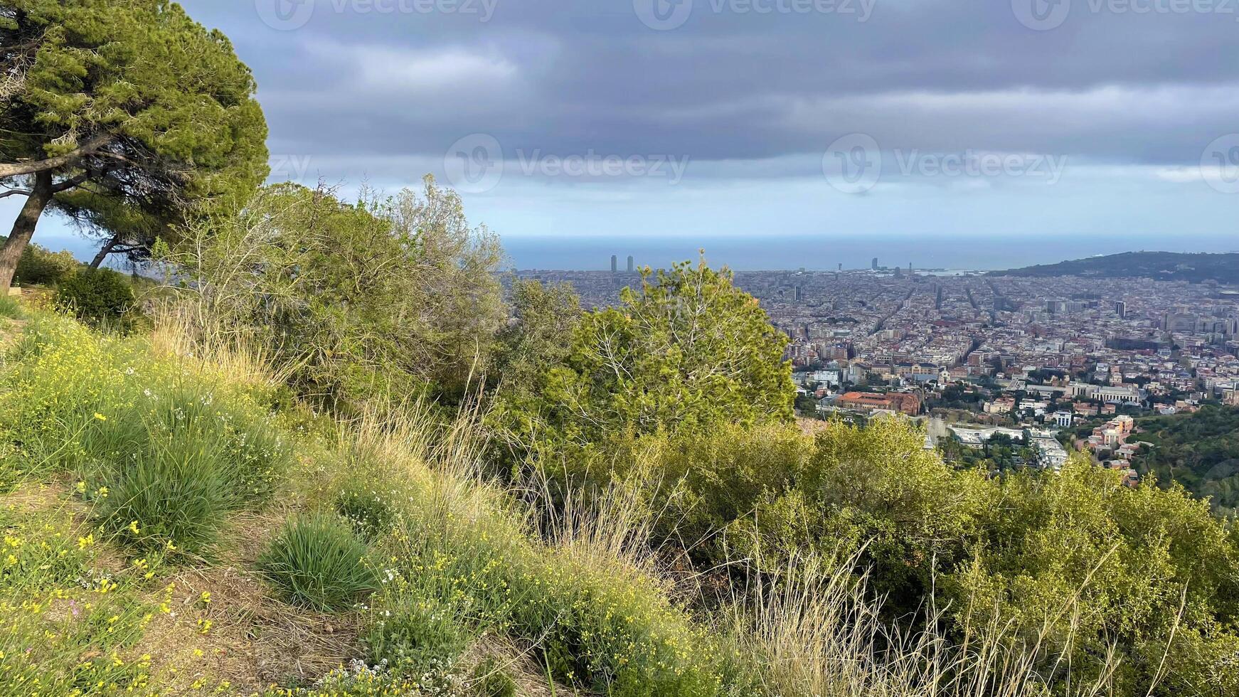 Panoramic view of Barcelona city from the hill, rainy spring weather landscape photo