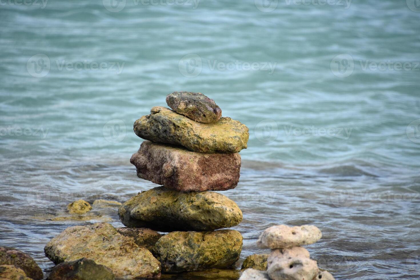 Rocks Stacked and Balancing by the Water photo