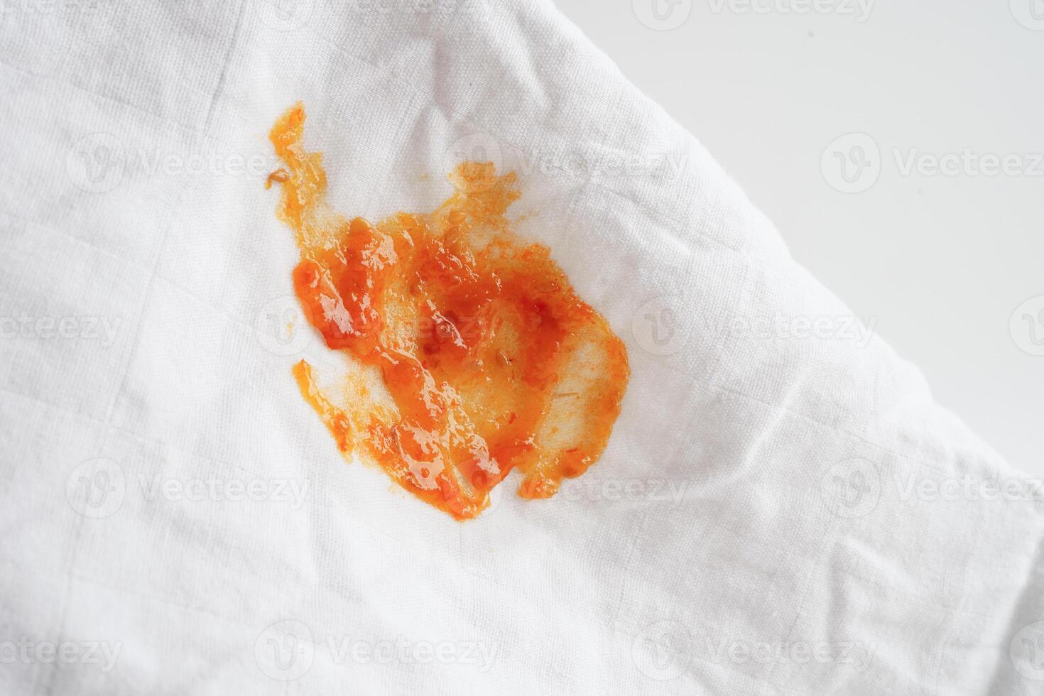 Dirty spicy sauce stain on cloth to wash with washing powder, cleaning housework concept. photo