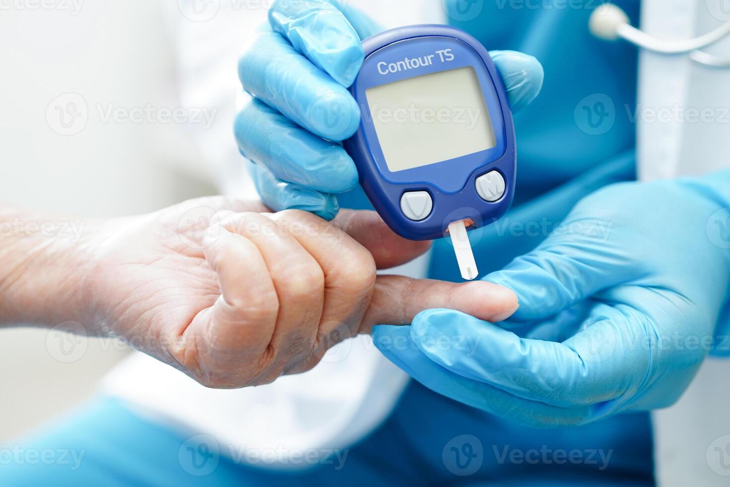 Asian doctor using digital glucose meter for check sample blood sugar level to treatment diabetes. photo