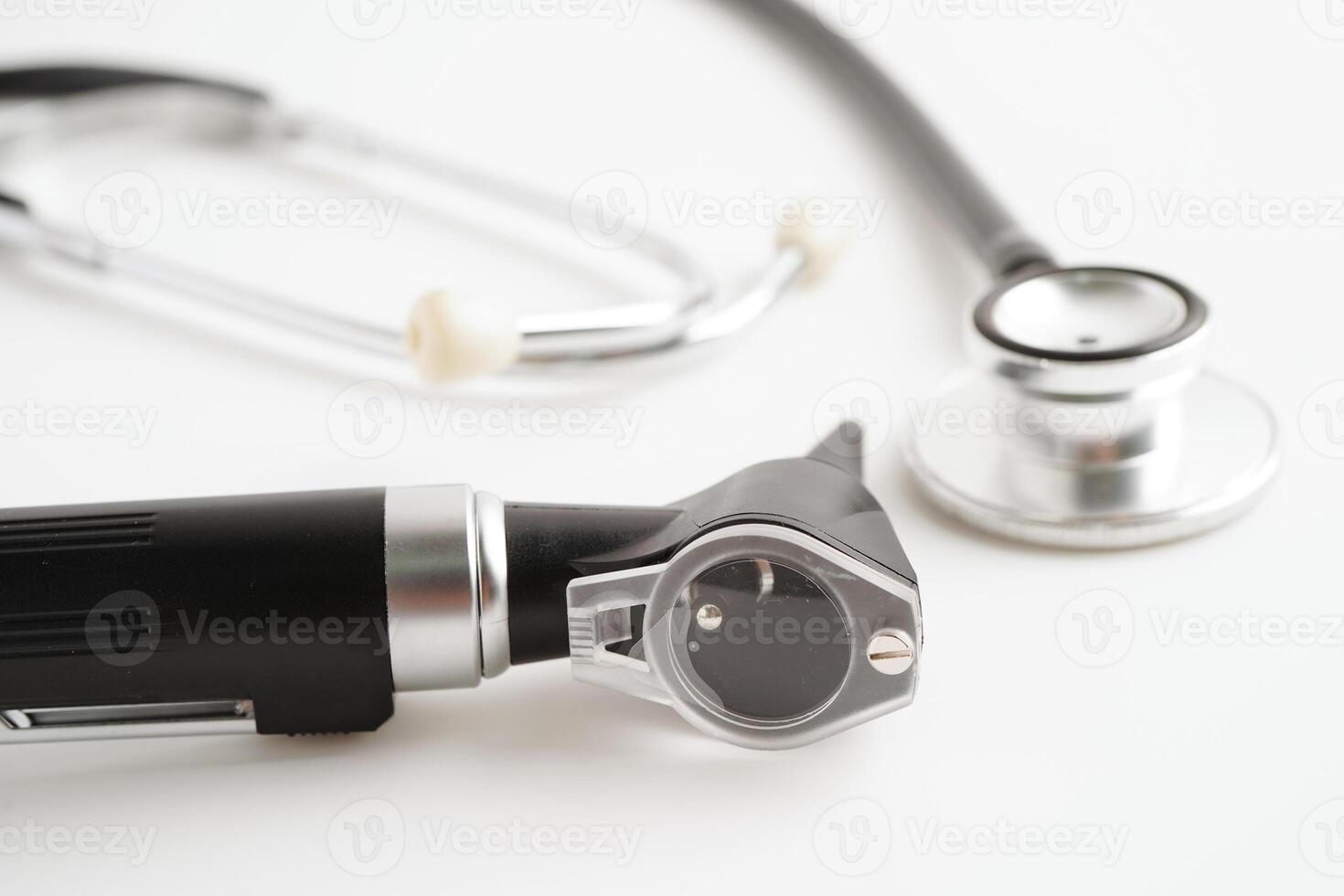 Otoscope isolated on white background for otolaryngologist or ENT physician doctor examining senior patient ear, hearing loss problem. photo
