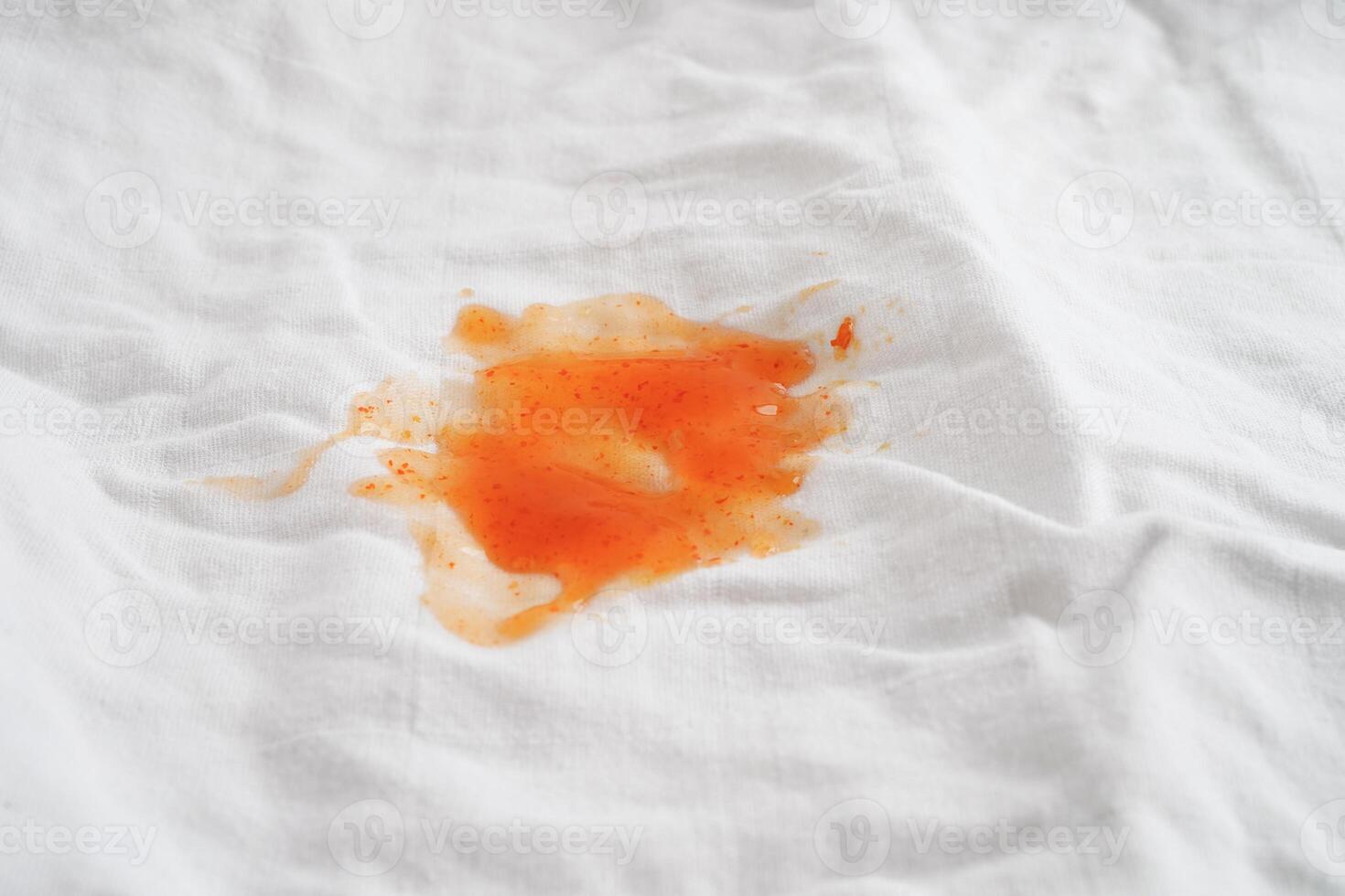 Dirty tomato sauce stain or ketchup on cloth to wash with washing powder, cleaning housework concept. photo