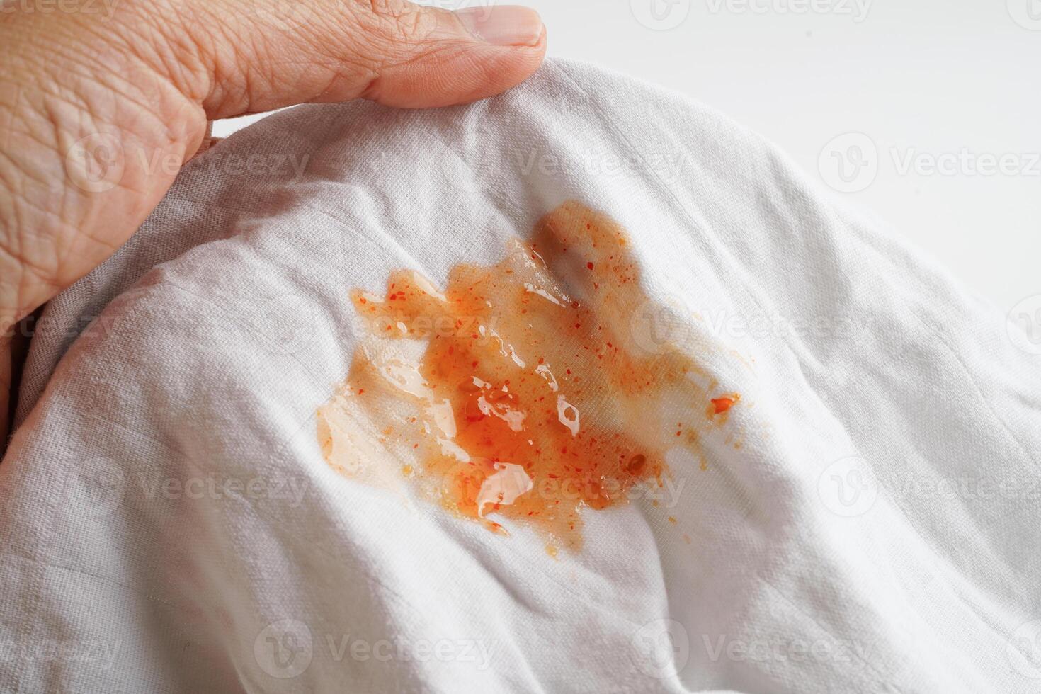 Dirty tomato sauce stain or ketchup on cloth to wash with washing powder, cleaning housework concept. photo