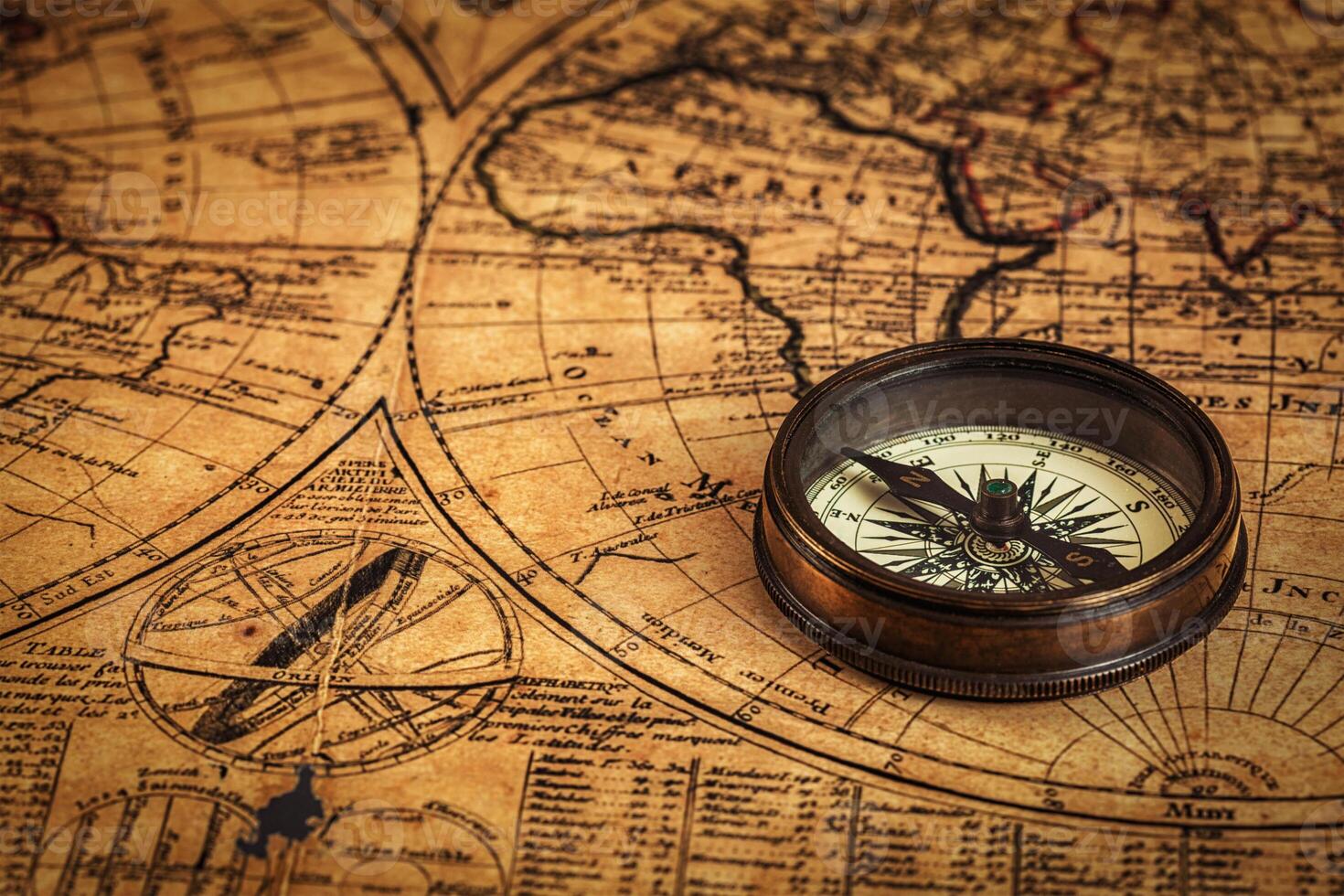 Old vintage compass on ancient map photo