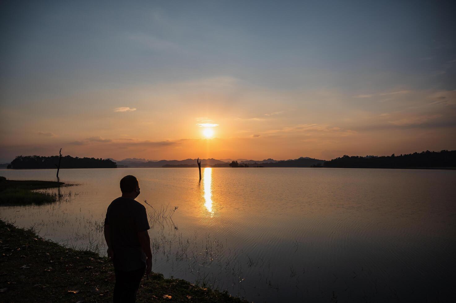 grasa hombre vistiendo máscara con puesta de sol ver de pom pipí ver punto.pom pipí punto de vista es situado en Khao laem nacional parque, correa Pha phum distrito, Kanchanaburi provincia foto