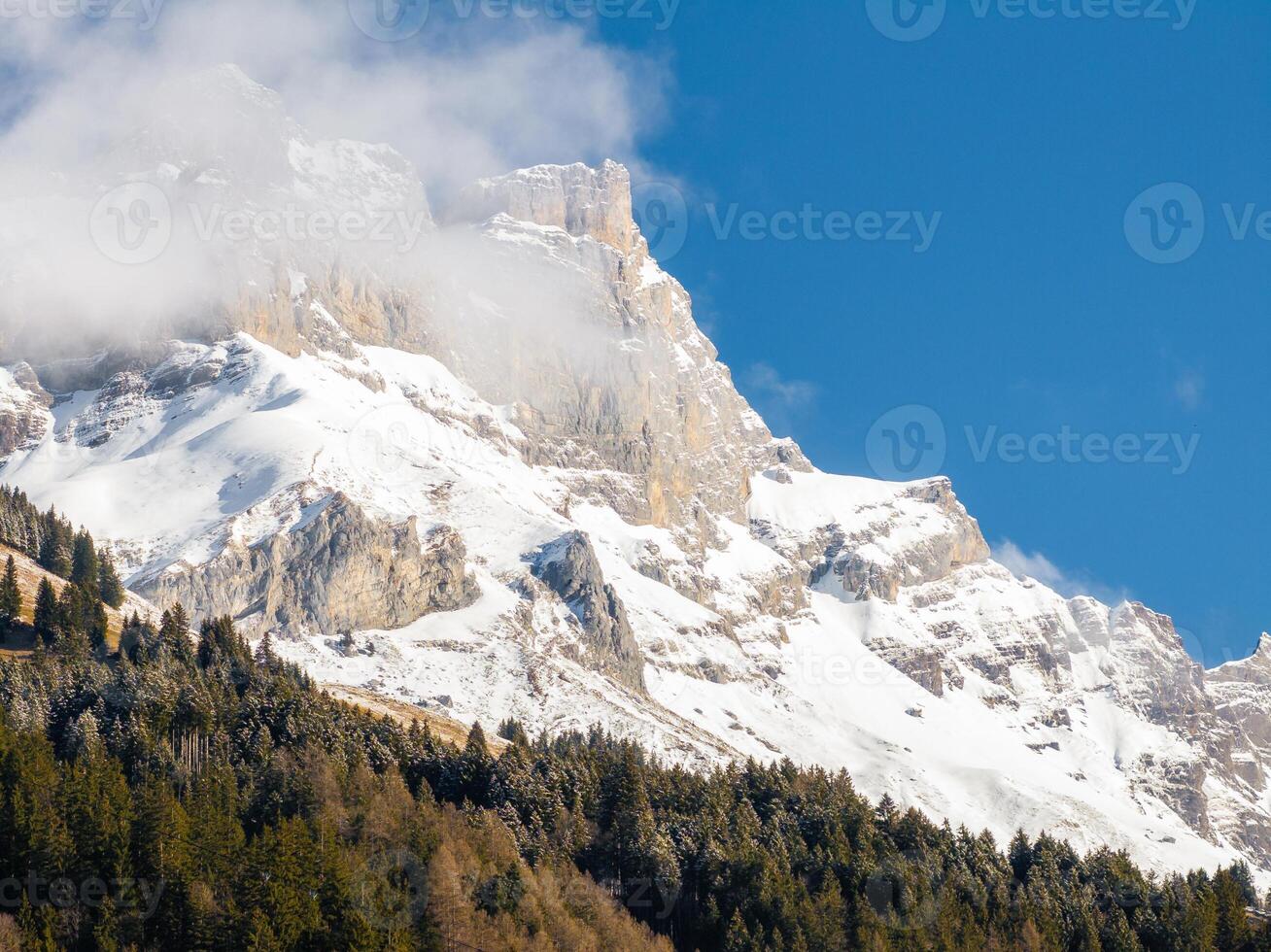 Majestic Alpine Mountain shrouded in Mist, located in Engelberg, Switzerland. photo