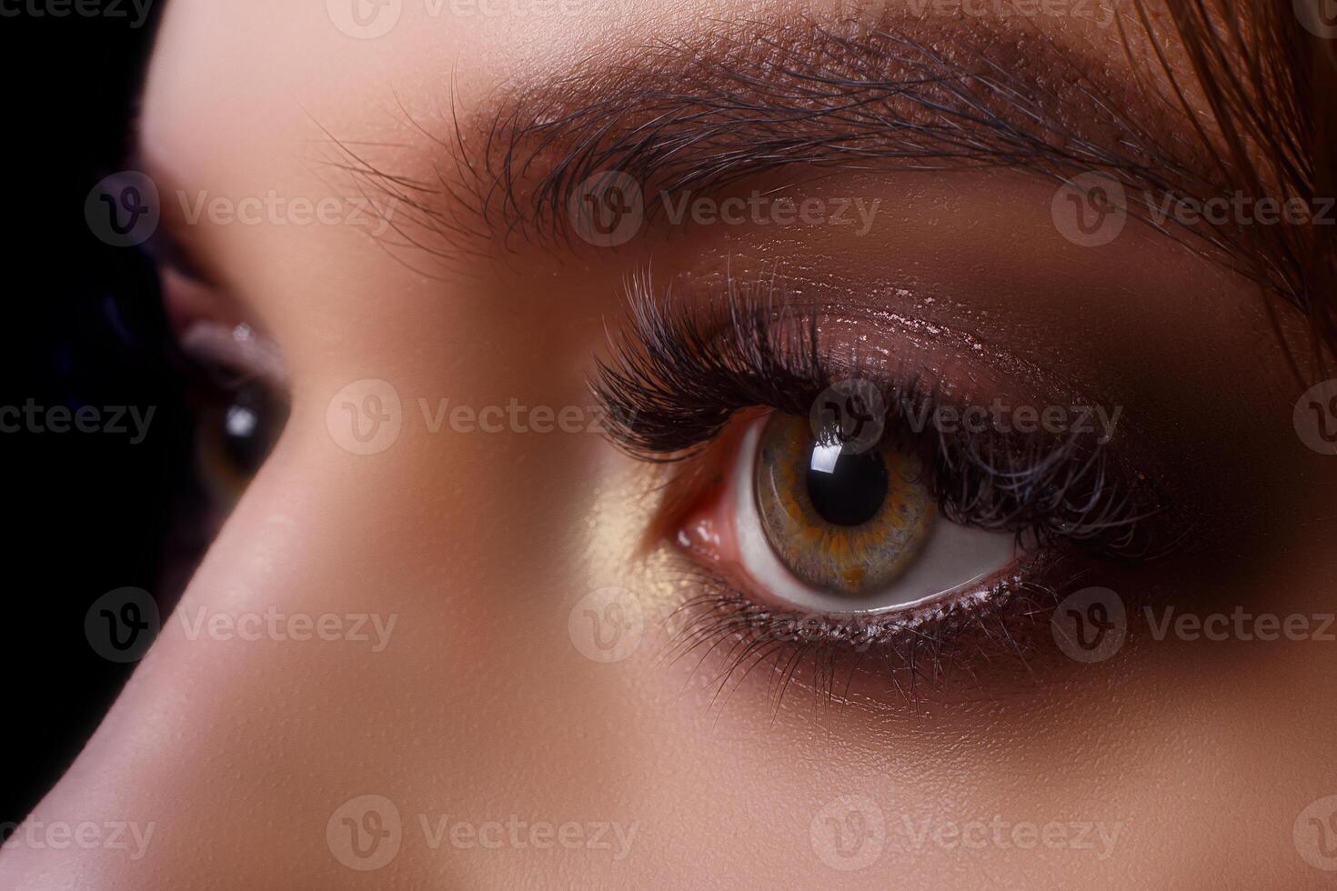 Eyelash Extension Procedure. Woman Eye with Long Eyelashes after Extension Procedure. White eyelashes. Dark background. Makeup. Close up, selective focus. photo