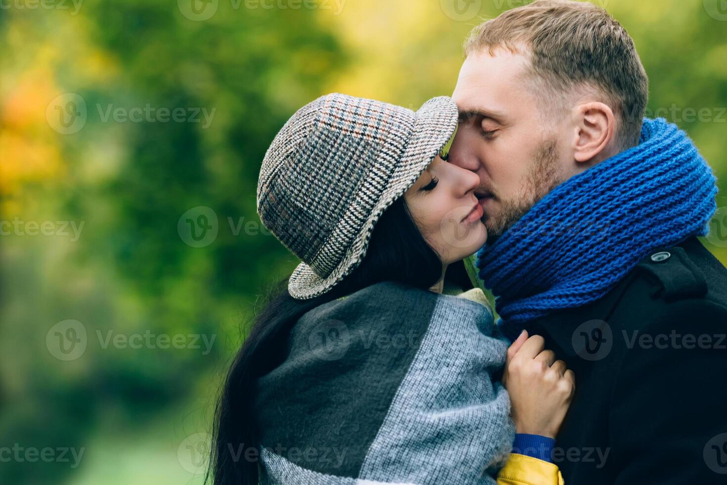 Young people in autumn park. Yellow Trees and Leaves. Happy young family concept. photo