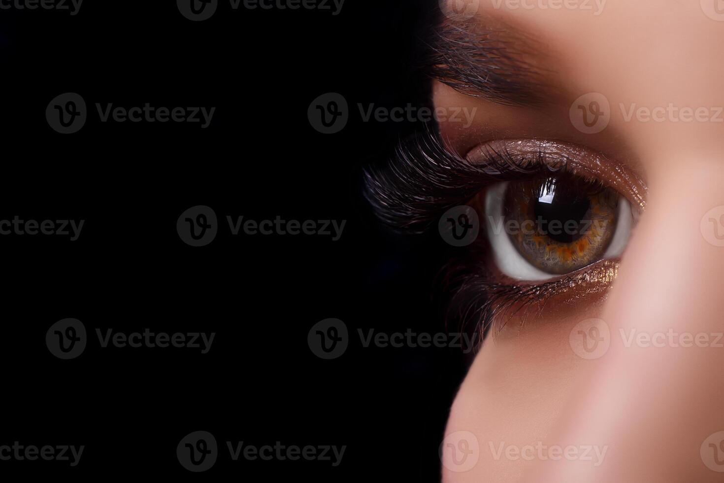 Eyelash Extension Procedure. Woman Eye with Long Eyelashes after Extension Procedure. White eyelashes. Dark background. Makeup. Close up, selective focus. photo