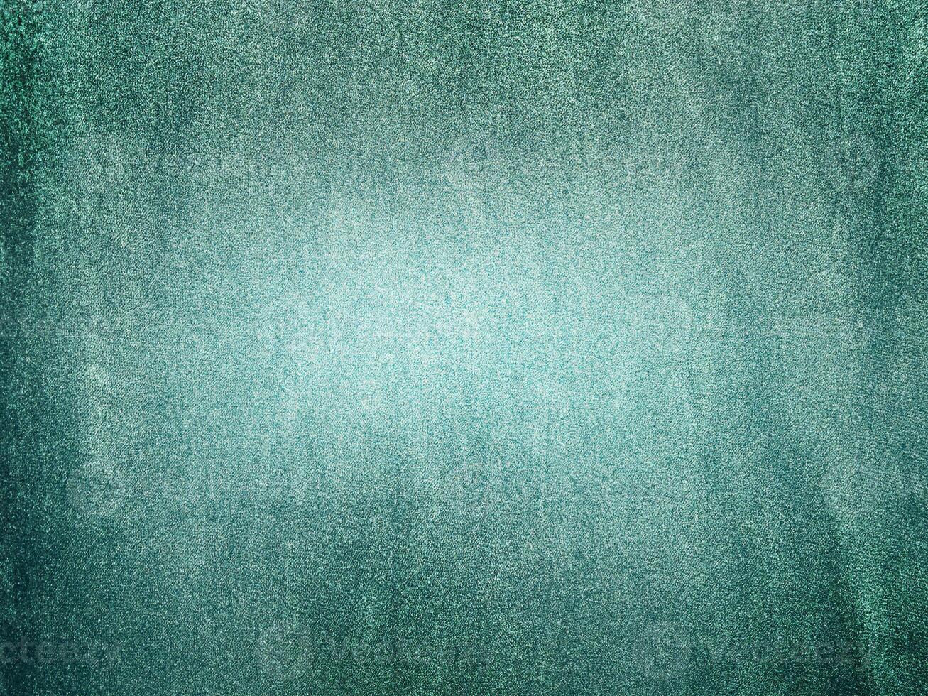 Green velvet background light and dark part. Macro photo of green velor fabric.