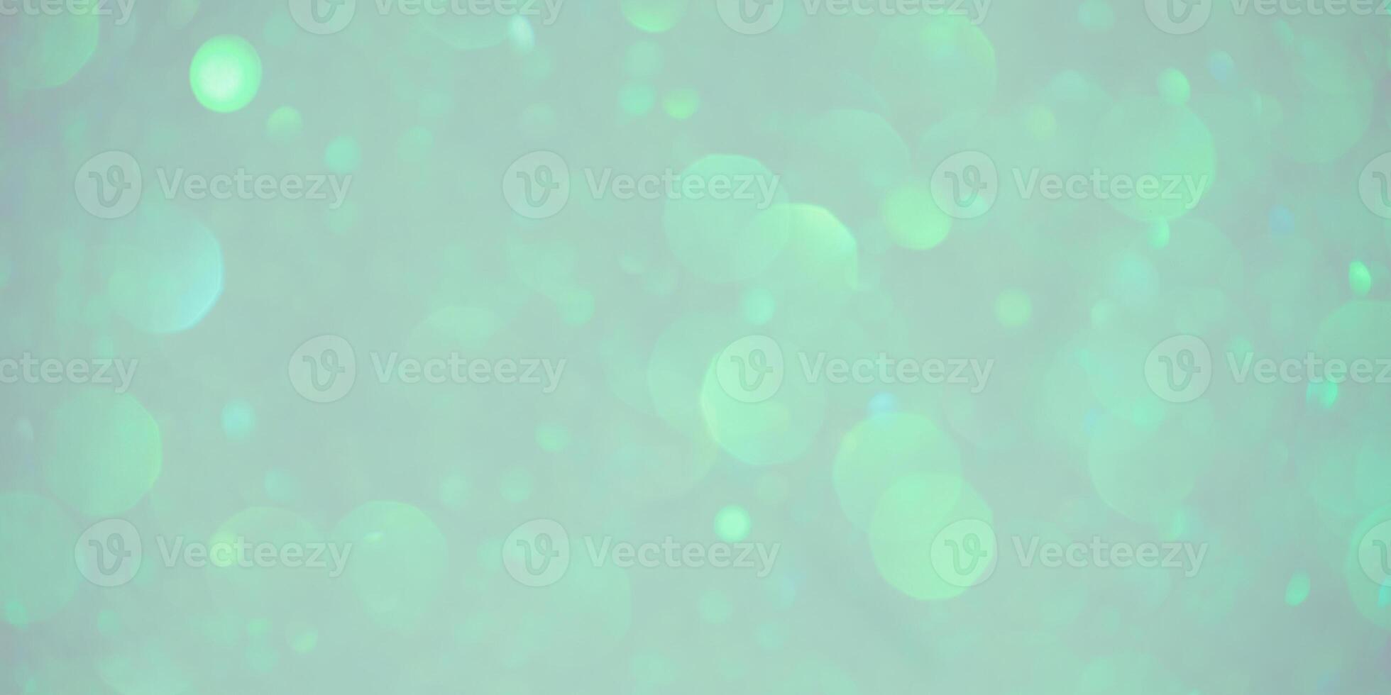 Beige background with green and blue defocus lights. Abstract glitter background. Bokeh photo