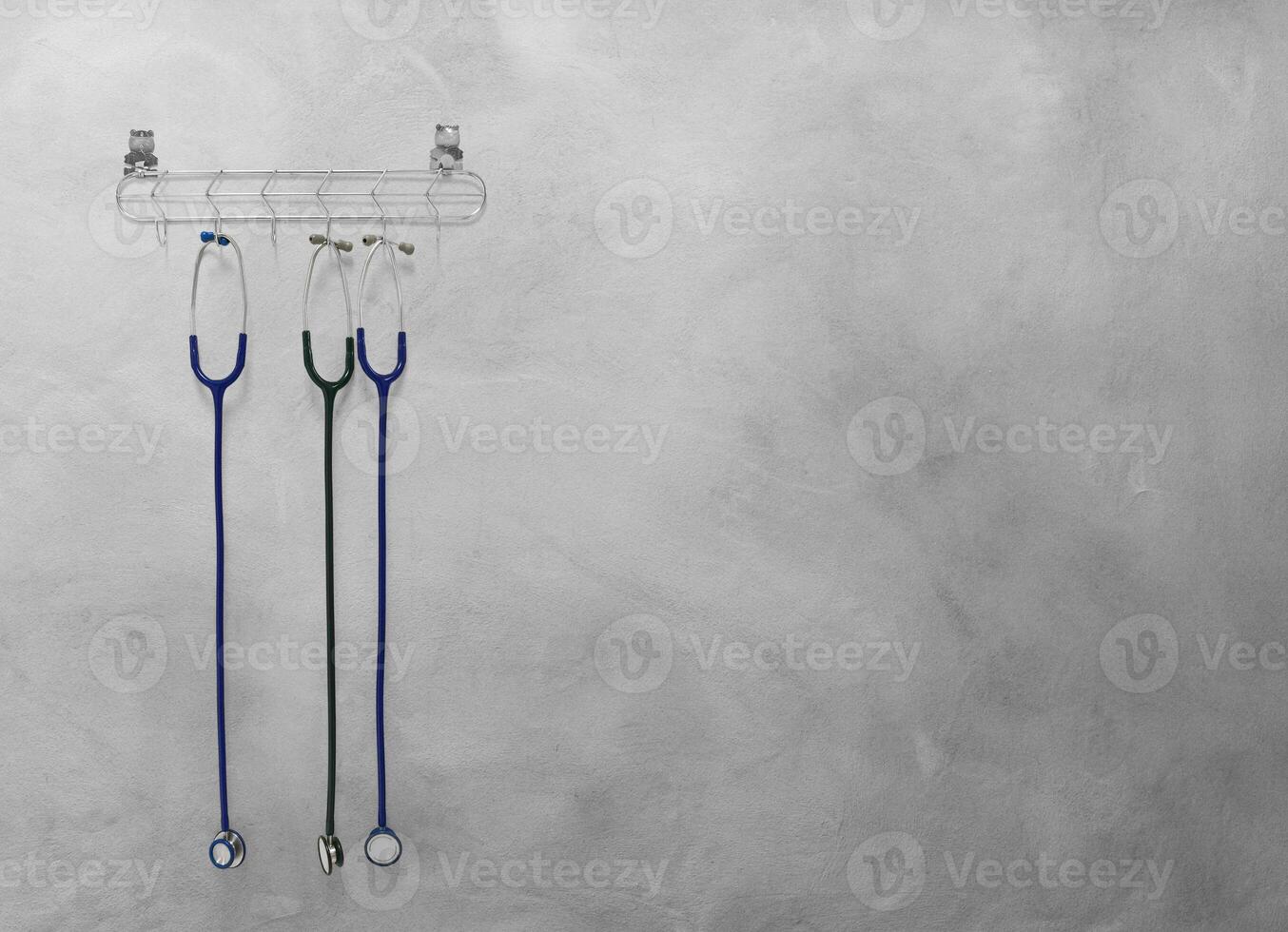 Stethoscope hanging on cement background photo