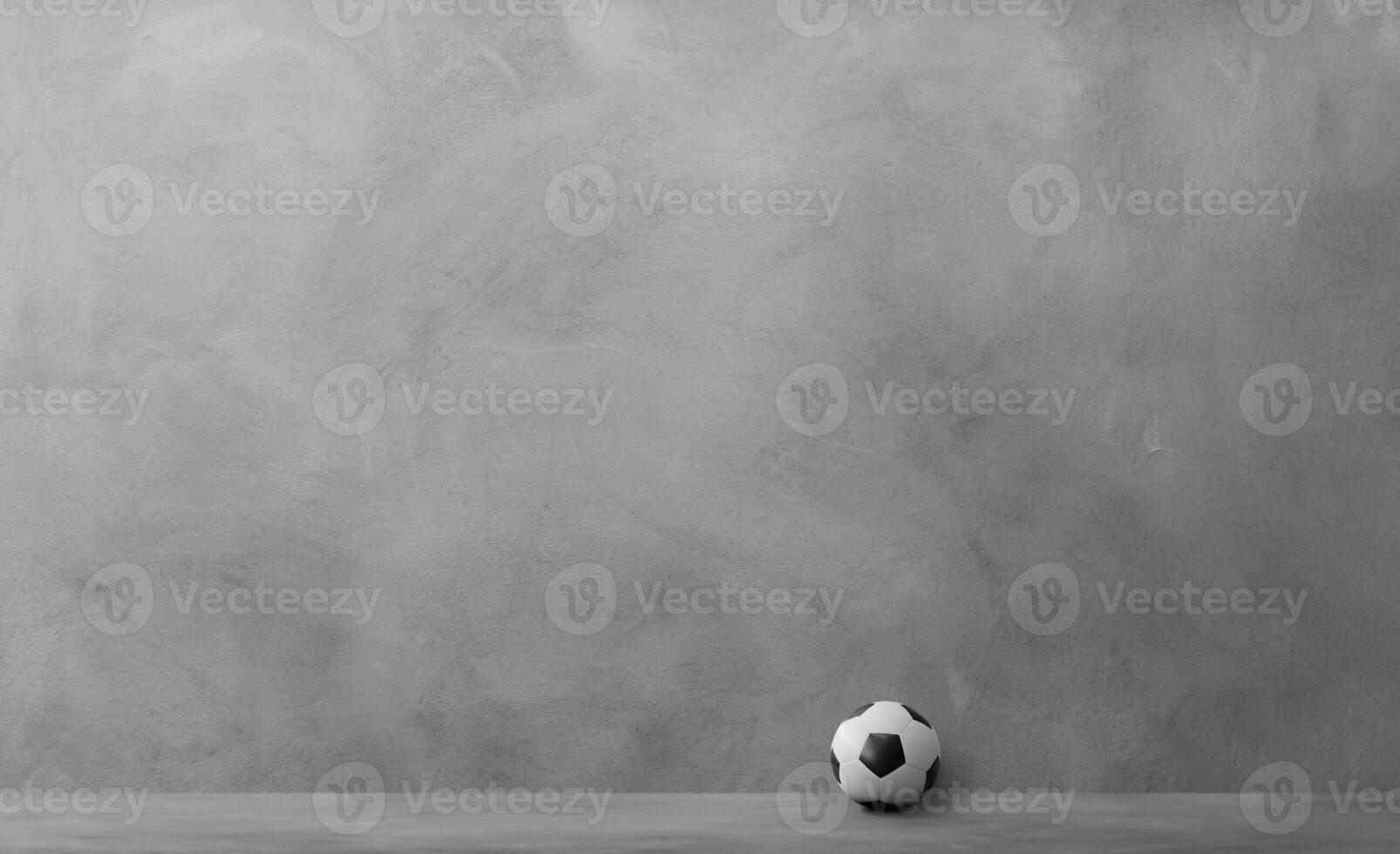 Soccer ball with light and shadow on the cement floor photo