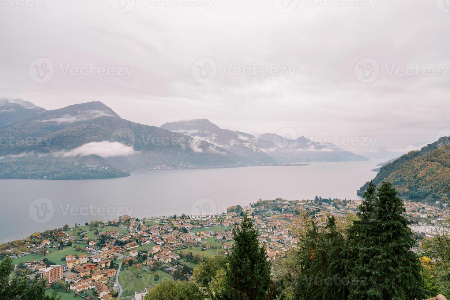 Colorful villas in a resort town on Lake Como overlooking the misty mountains. Italy photo