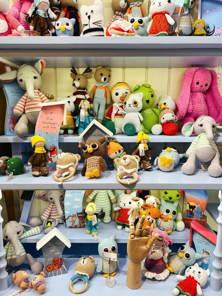 Kotor, Montenegro - 25 december 2022. Multi-colored soft knitted toys on the shelves in the store photo