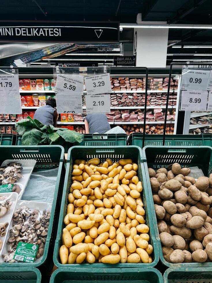 Budva, Montenegro - 25 december 2022. Fresh vegetables lie in plastic boxes in the supermarket photo