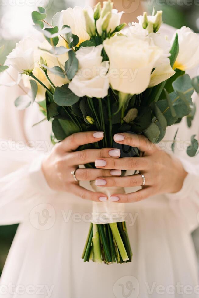 Wedding bouquet in the hands of the bride. Cropped. Faceless photo