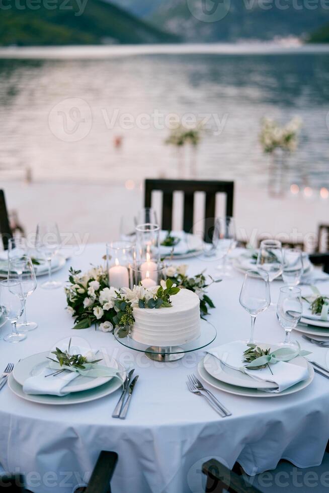 Wedding cake stands on a stand on a festive table set photo