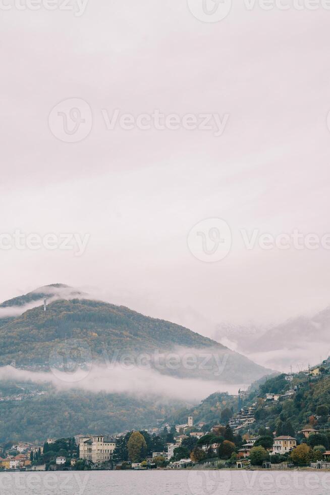 Fog over the mountains on the shores of Lake Como. Italy photo