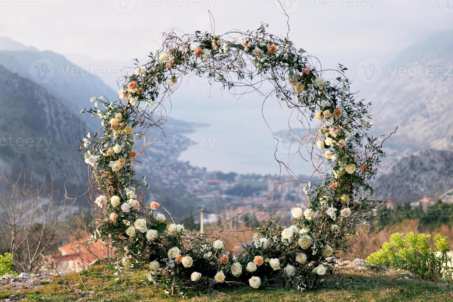 Round wedding arch stands on a mountain on the Bay of Kotor in the valley photo