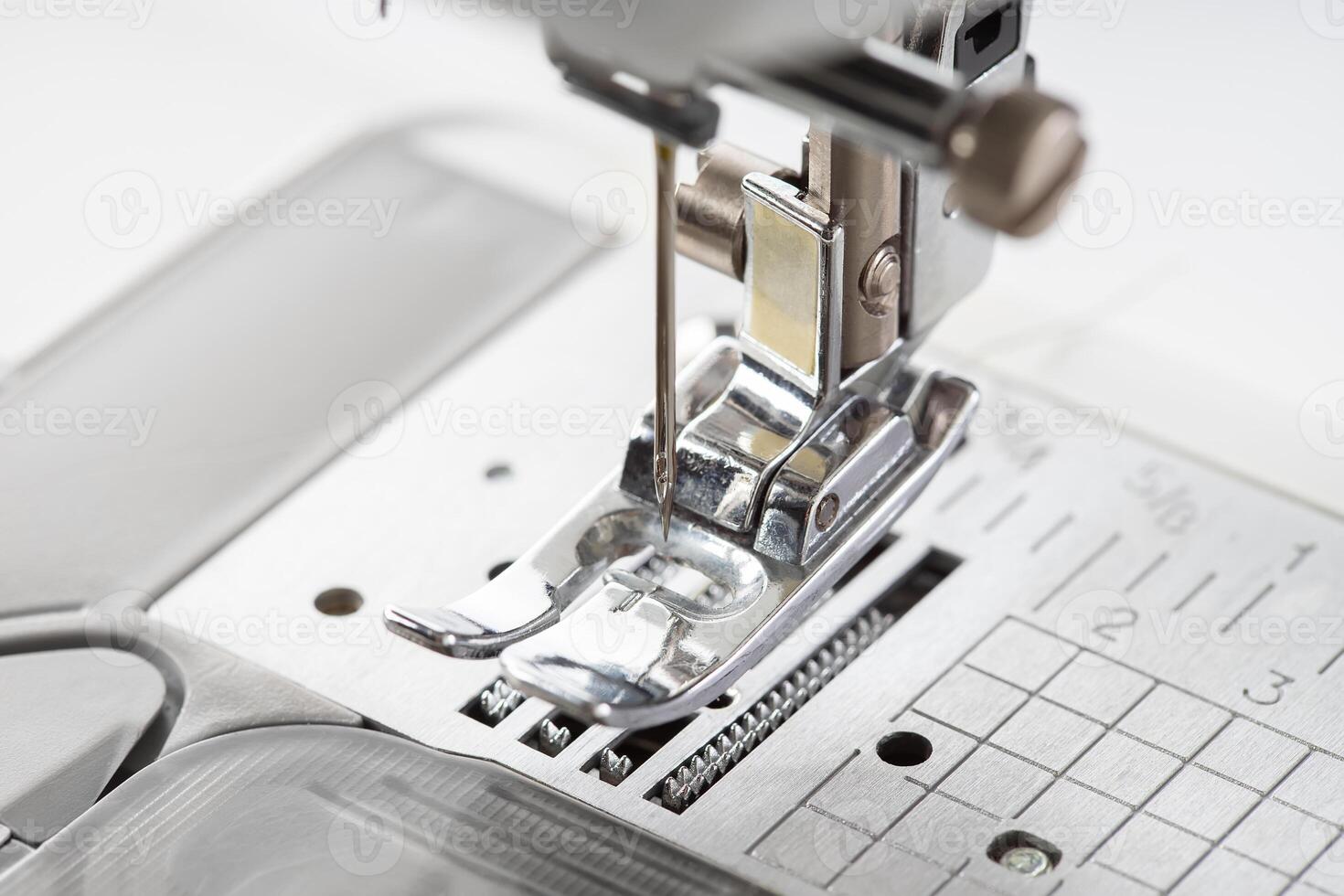 Modern white sewing machine presser foot closeup, macro photo
