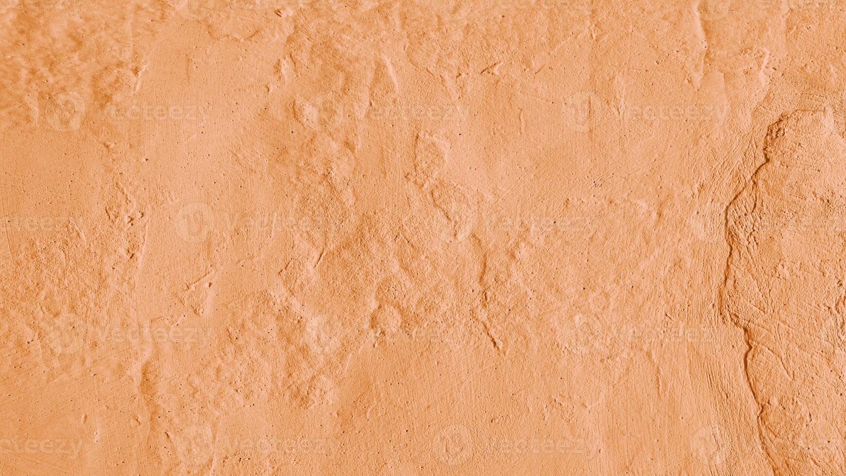Stucco plaster wall background texture of orange painted cement, concrete wall photo