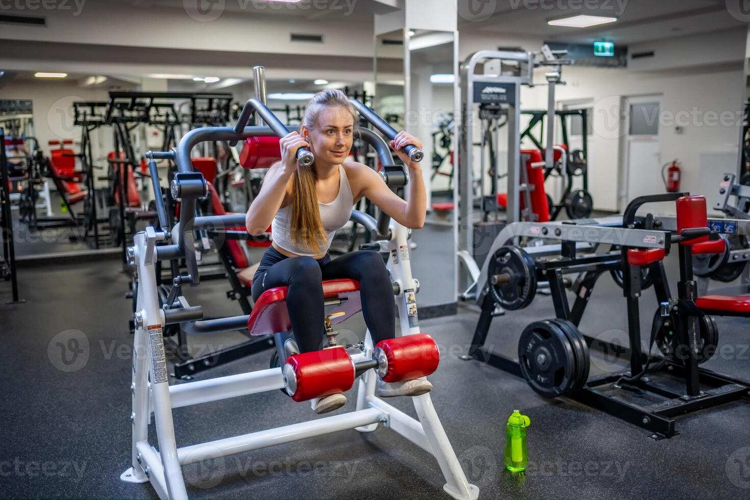 Young sport woman wearing sport wear doing exercise with fitness equipment at gym, she exercise for strong and good healthy. High quality photo