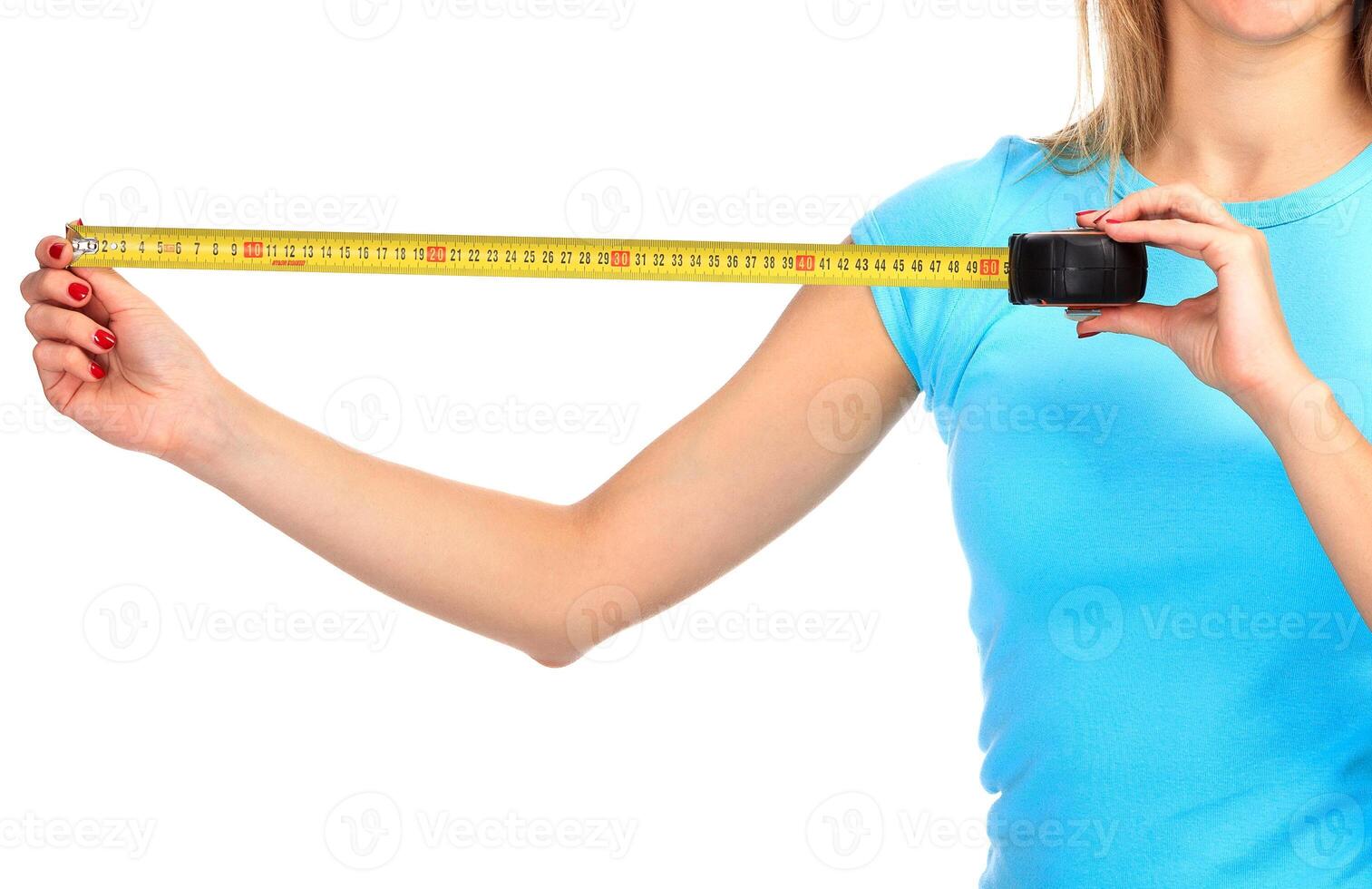 Woman shows a yellow measure tape photo