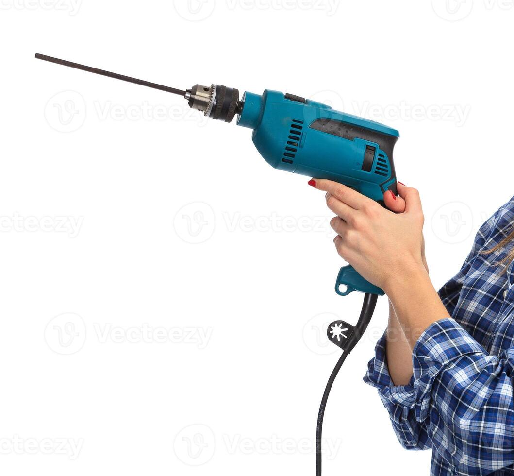 Woman holds a drill, isolated on a white background photo