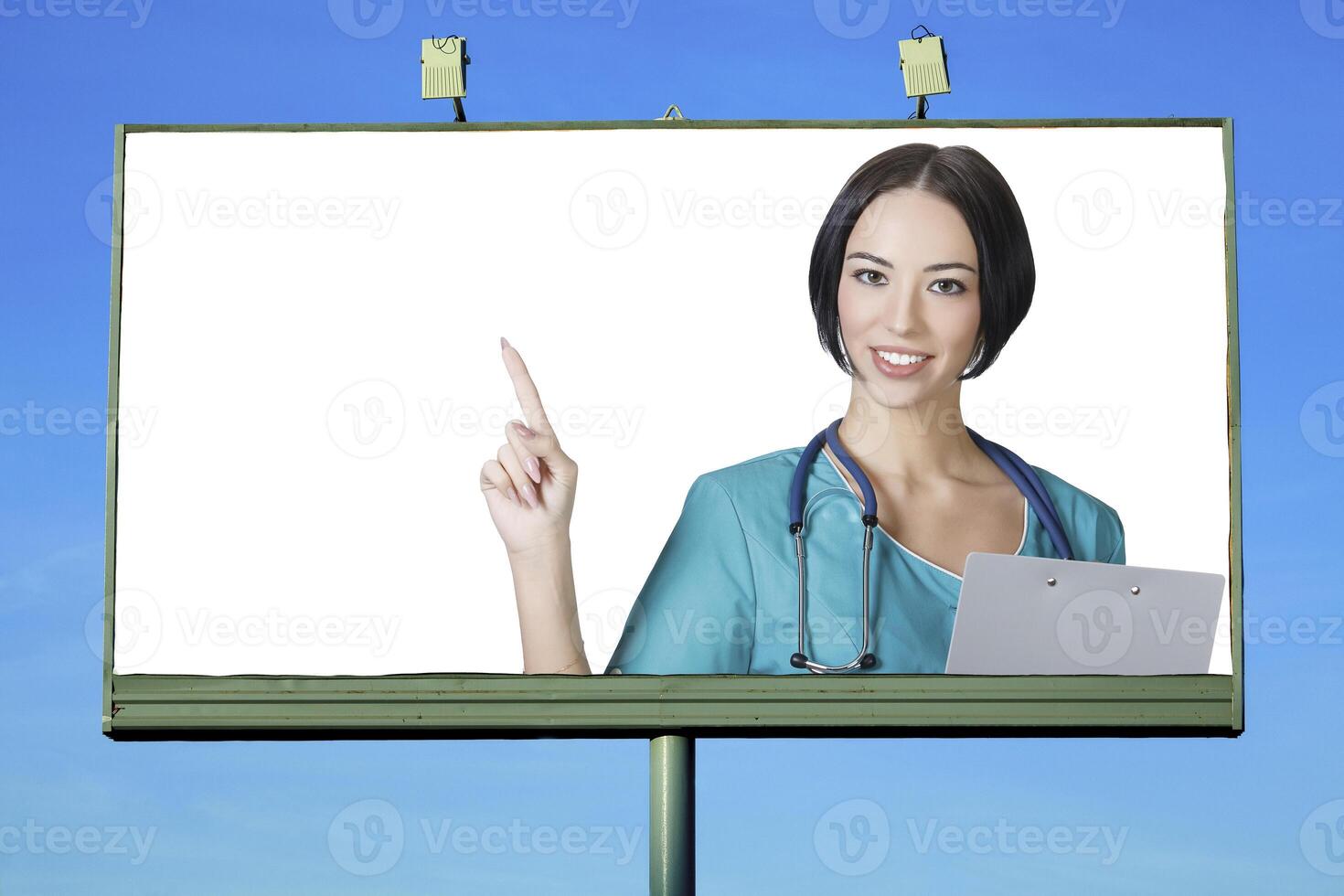 Pretty doctor smiling to you from billboard photo