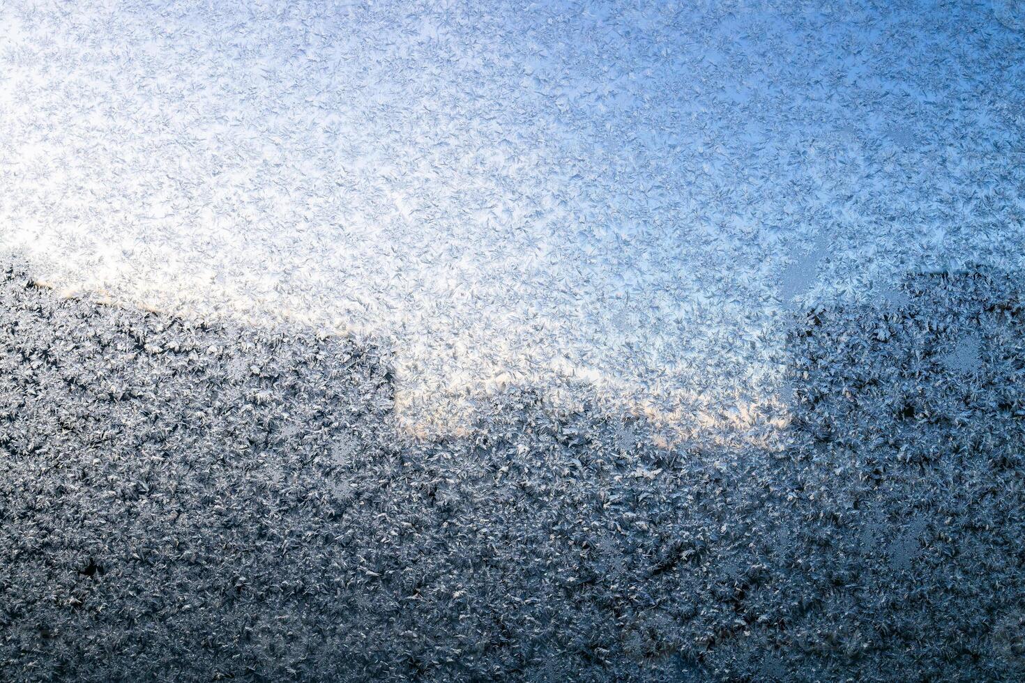 frosty pattern on window glass of apartment photo