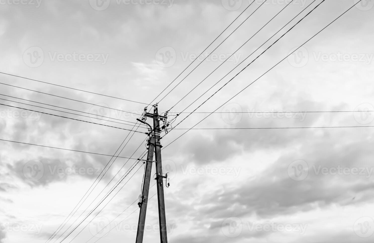 Power electric pole with line wire on light background close up photo