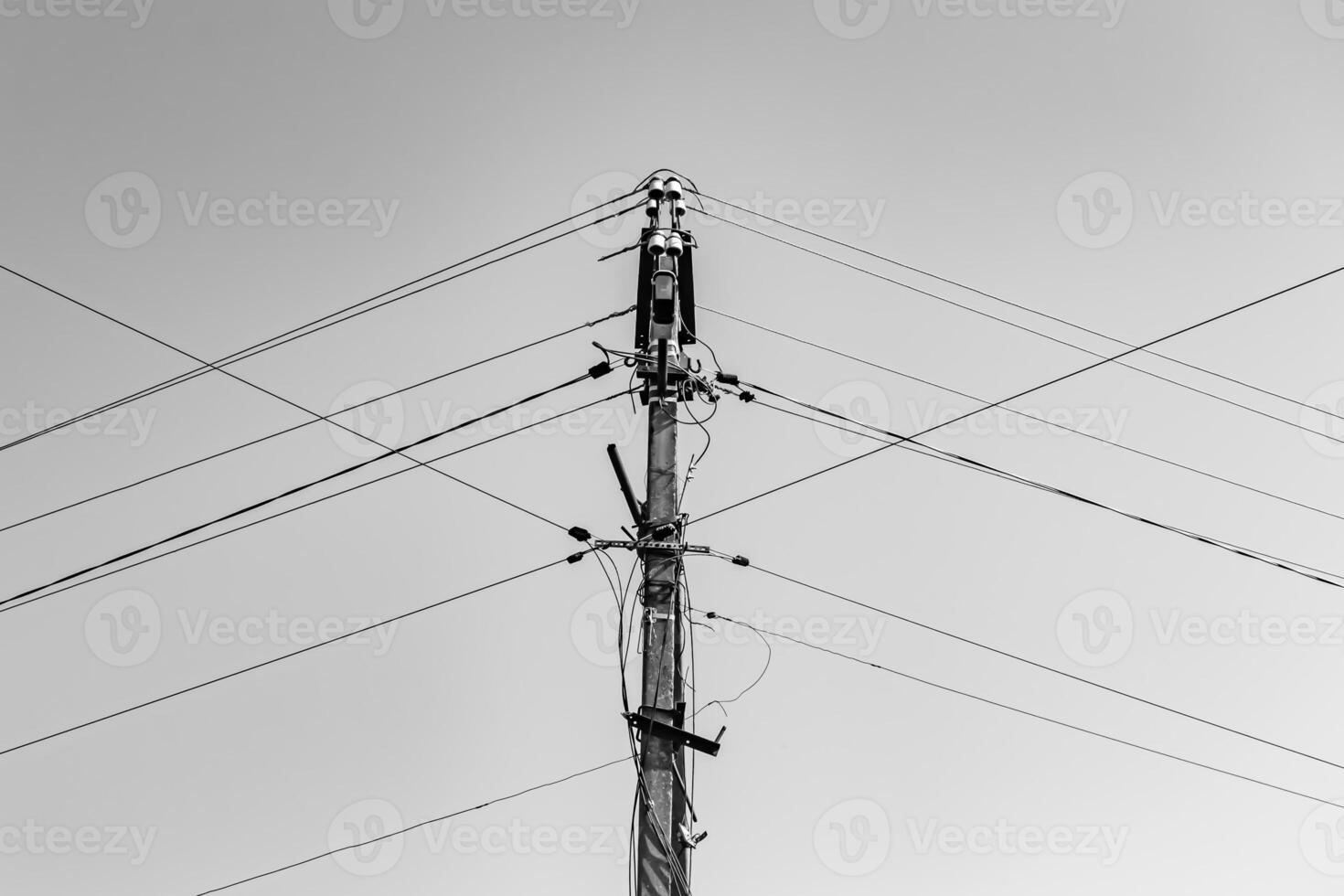 Power electric pole with line wire on light background close up photo