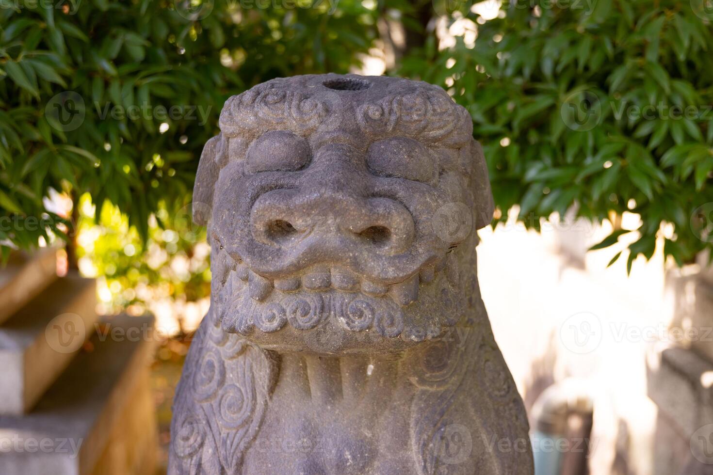 A guardian statue at Tomioka Shrine with copyspace photo