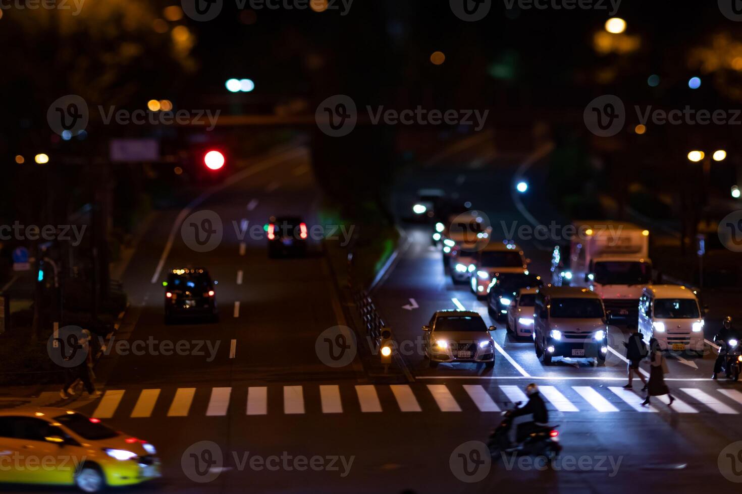 A night timelapse miniature traffic jam at the city crossing in Tokyo photo