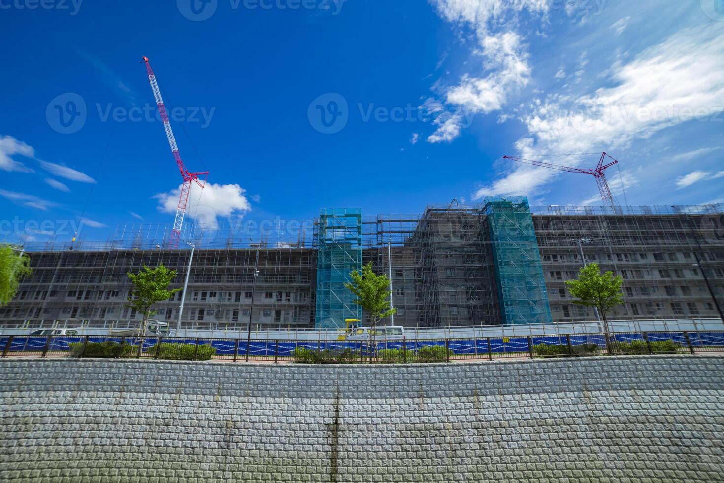 Cranes at the under construction daytime wide shot photo