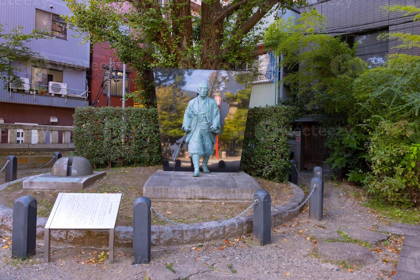 A Japanese stone statue at Tomioka Shrine with copyspace photo