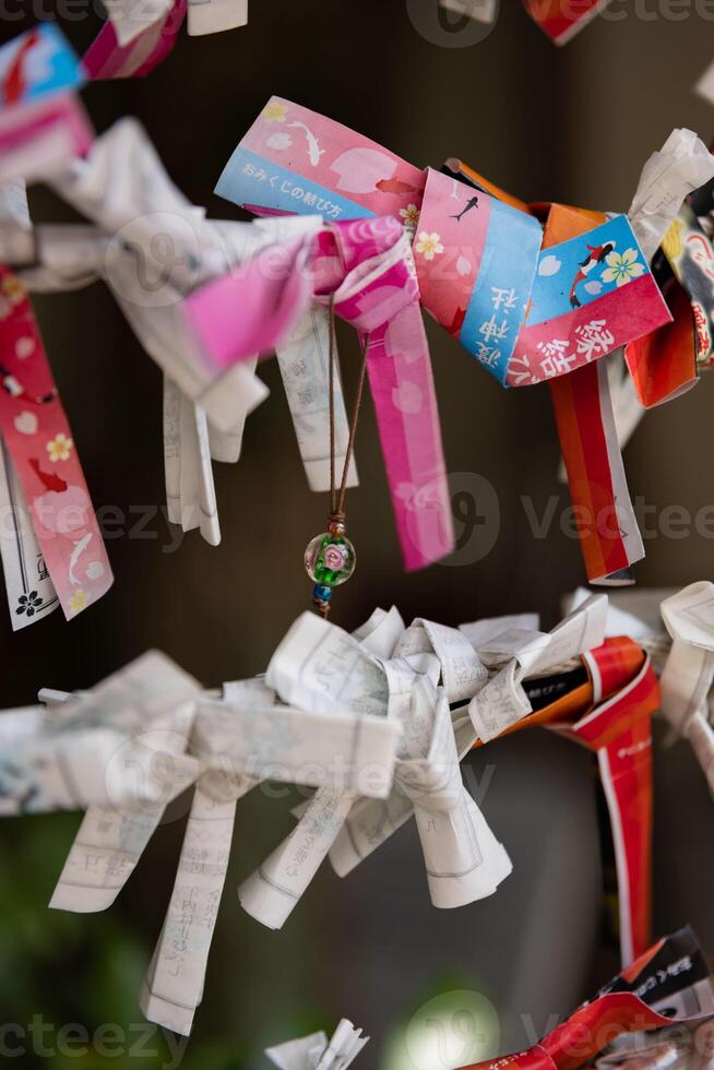 A fortune telling slip at Tomioka Shrine closeup photo