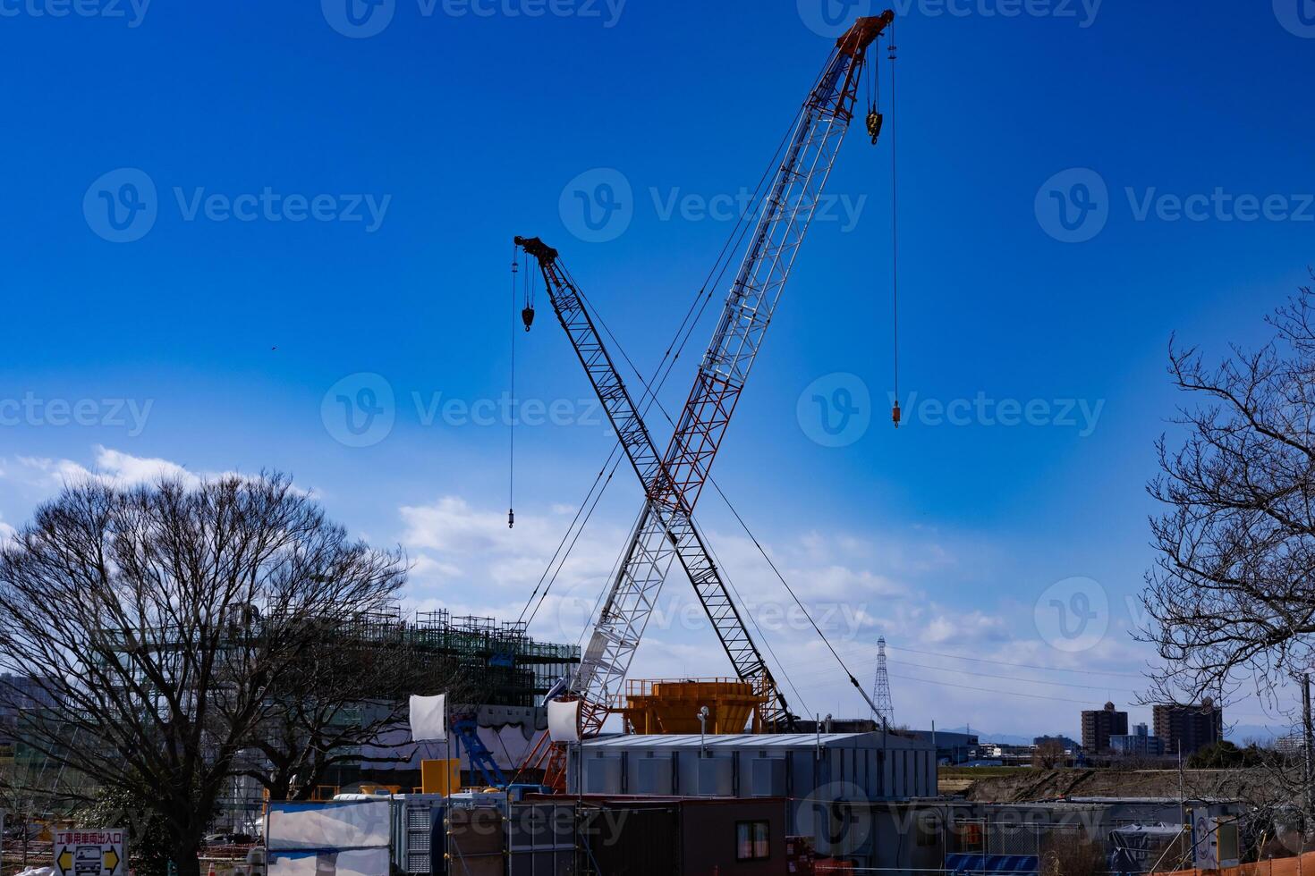 Cranes at the under construction daytime in Tokyo wide shot photo