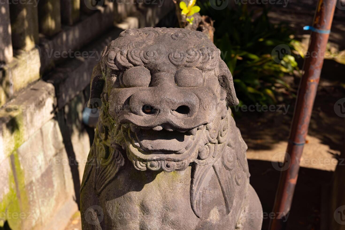 A guardian statue at Tomioka Shrine with copyspace photo