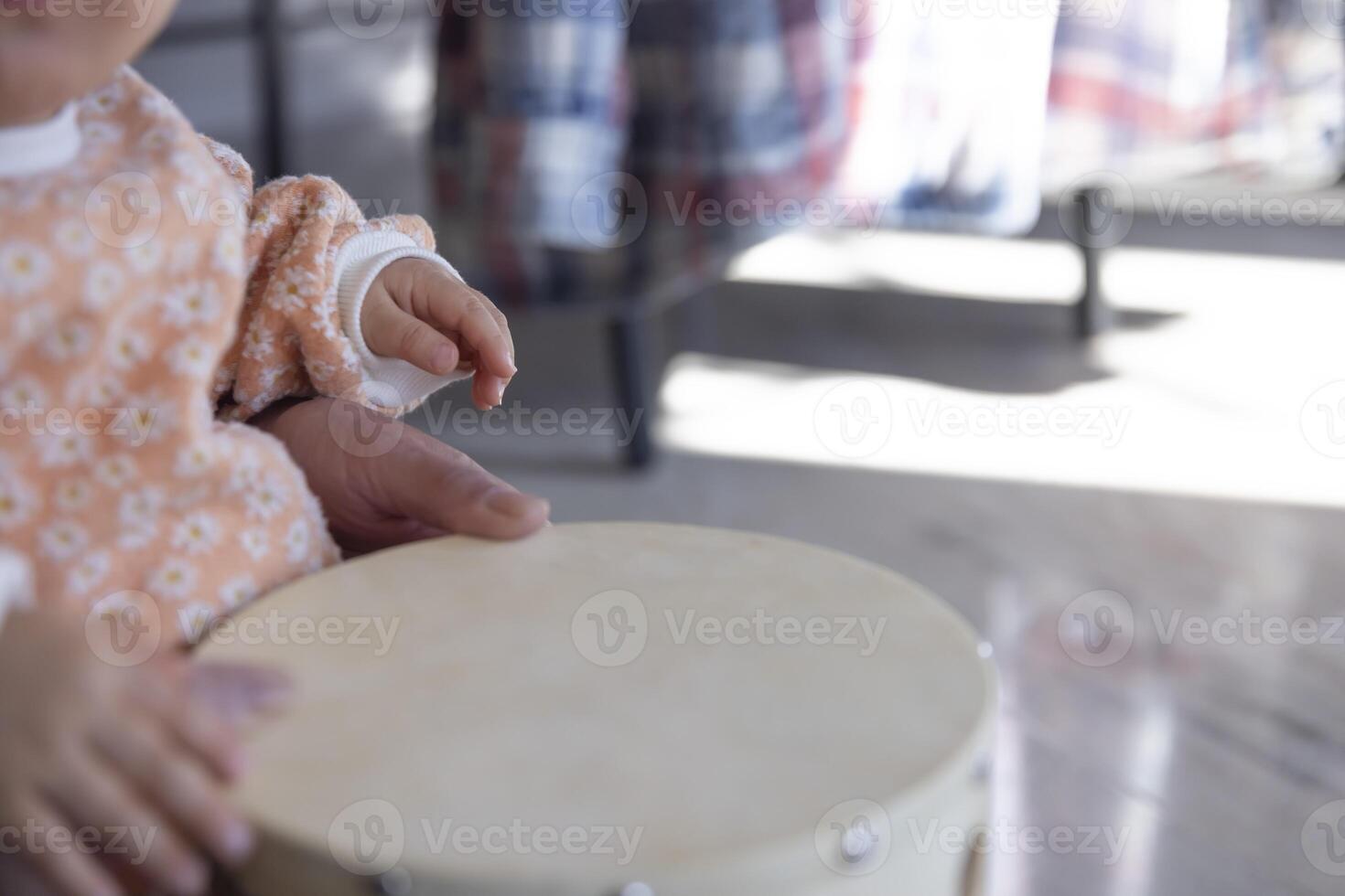 Child's hands with tambourine in the living room closeup photo